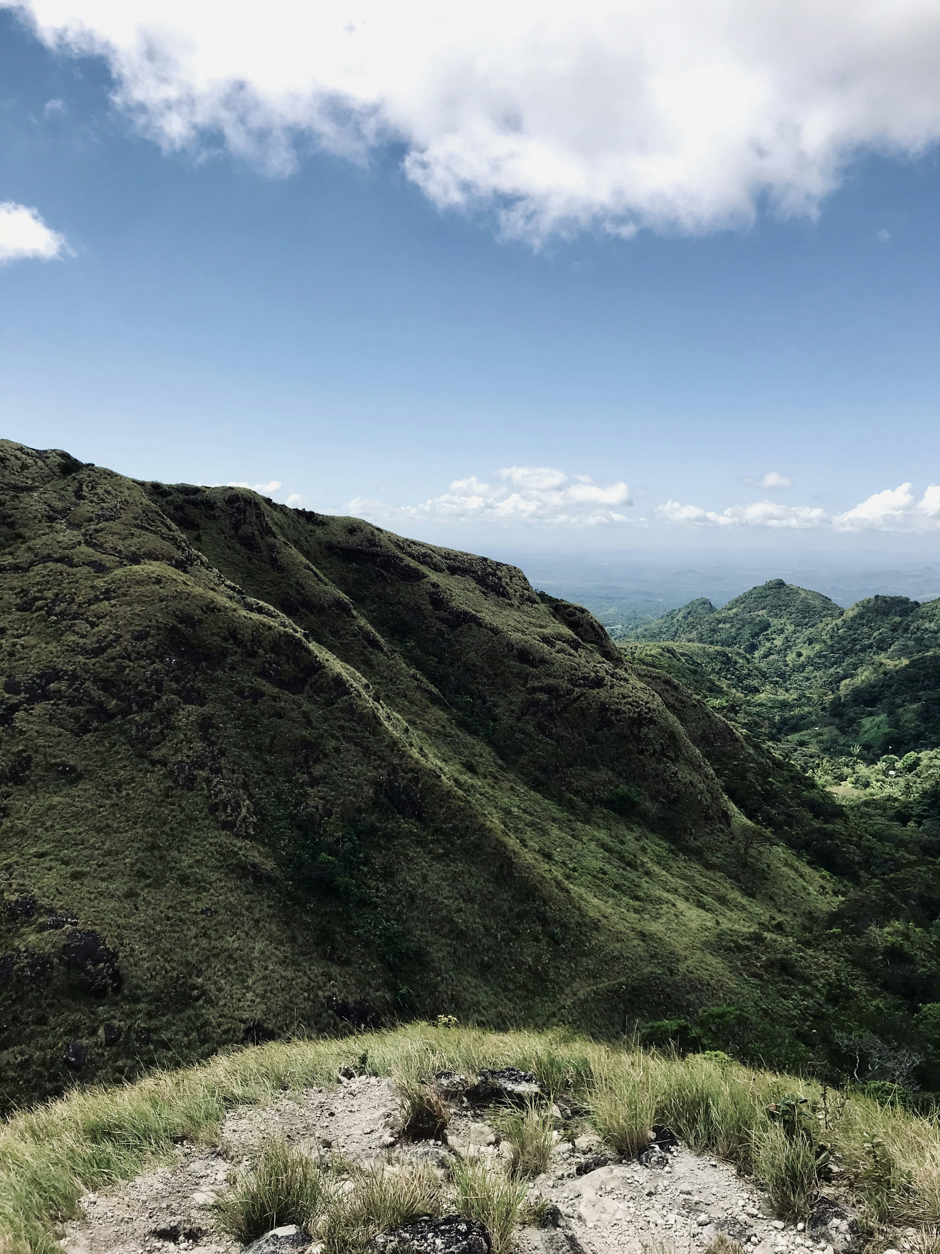 green grass covered mountain under blue sky during daytime
