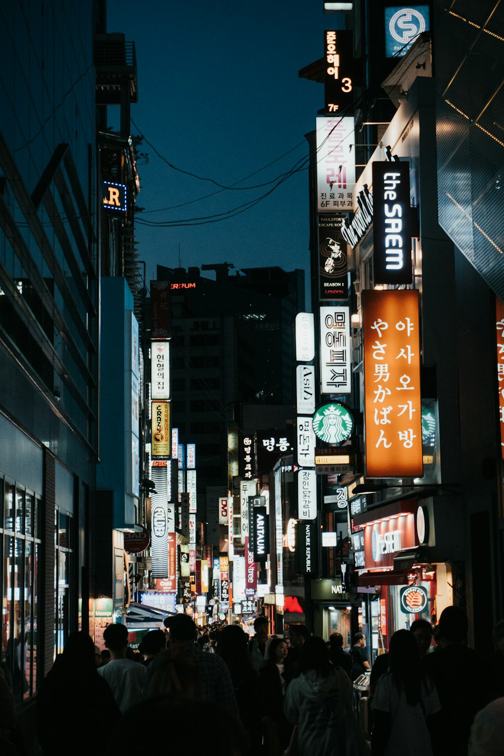 people walking on street during night time