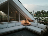 A beautifully designed backyard patio surrounded by lush greenery and soft lighting.