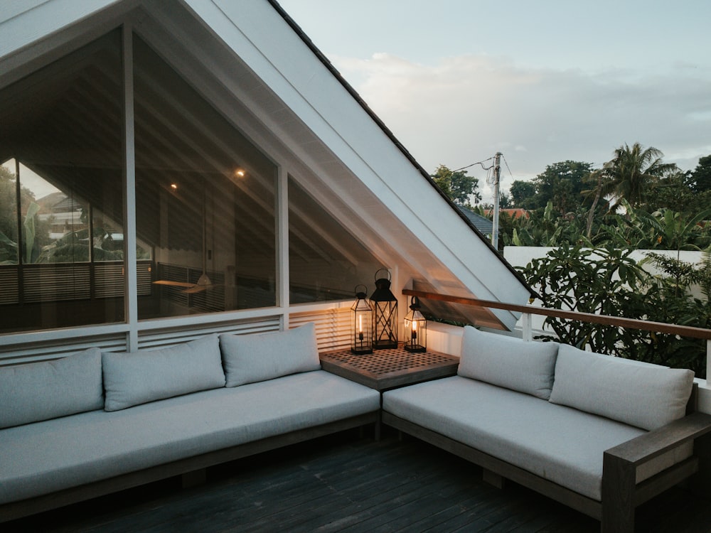 white and gray couch on gray wooden floor