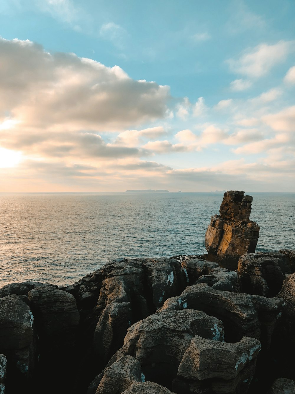 brown rock formation near body of water during daytime