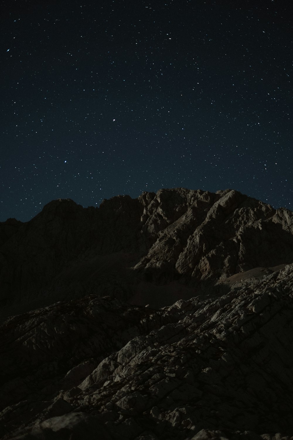 snow covered mountain under blue sky during night time