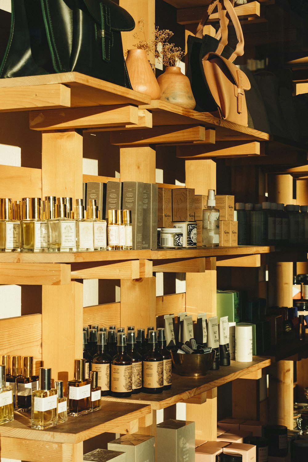 bottles on brown wooden shelf