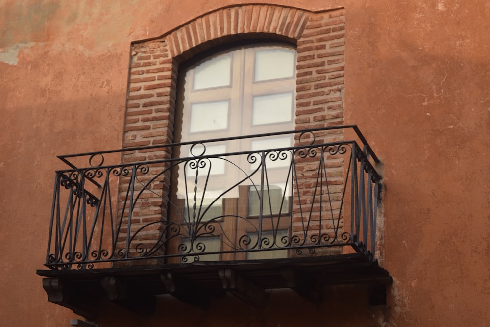 black metal window frame on brown brick wall