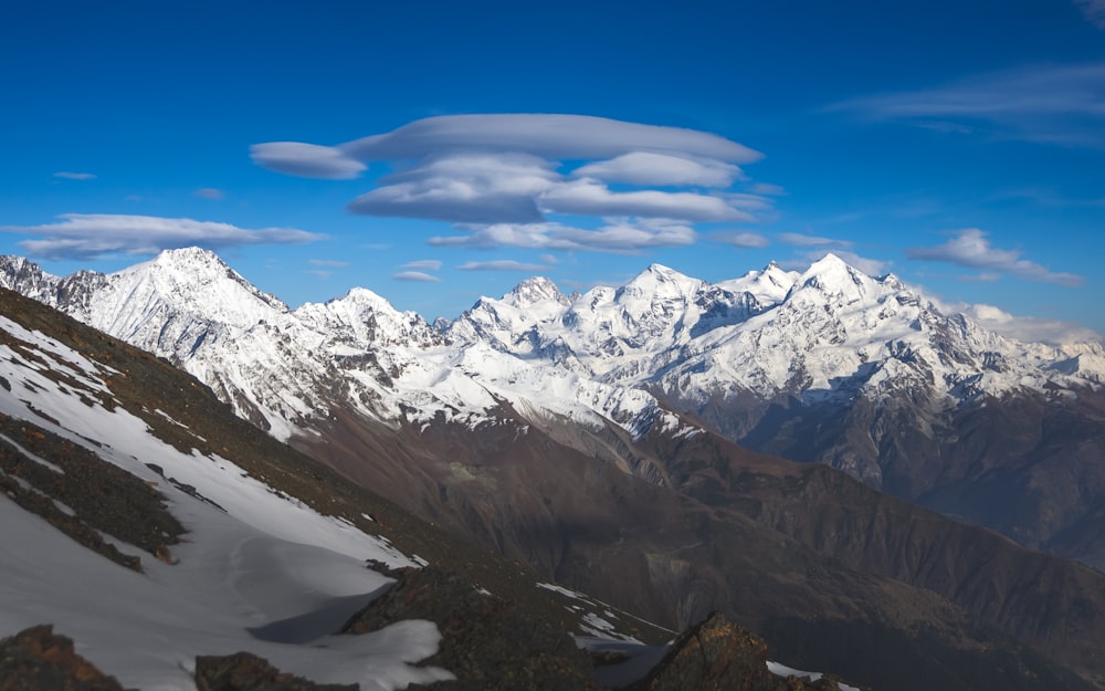 snow covered mountains under blue sky during daytime