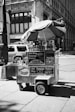 grayscale photo of utility truck with umbrella