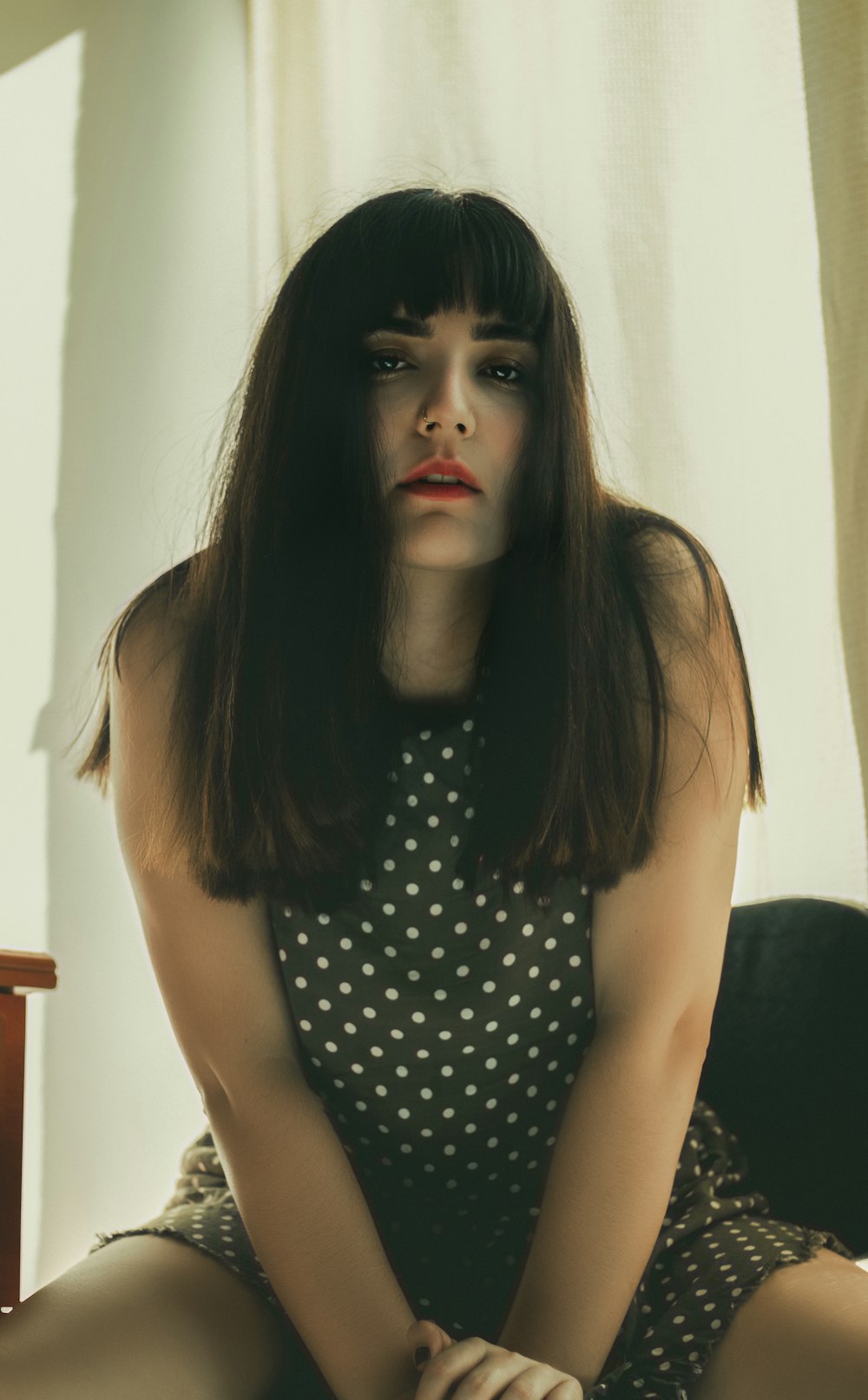 woman in black and white polka dot sleeveless top