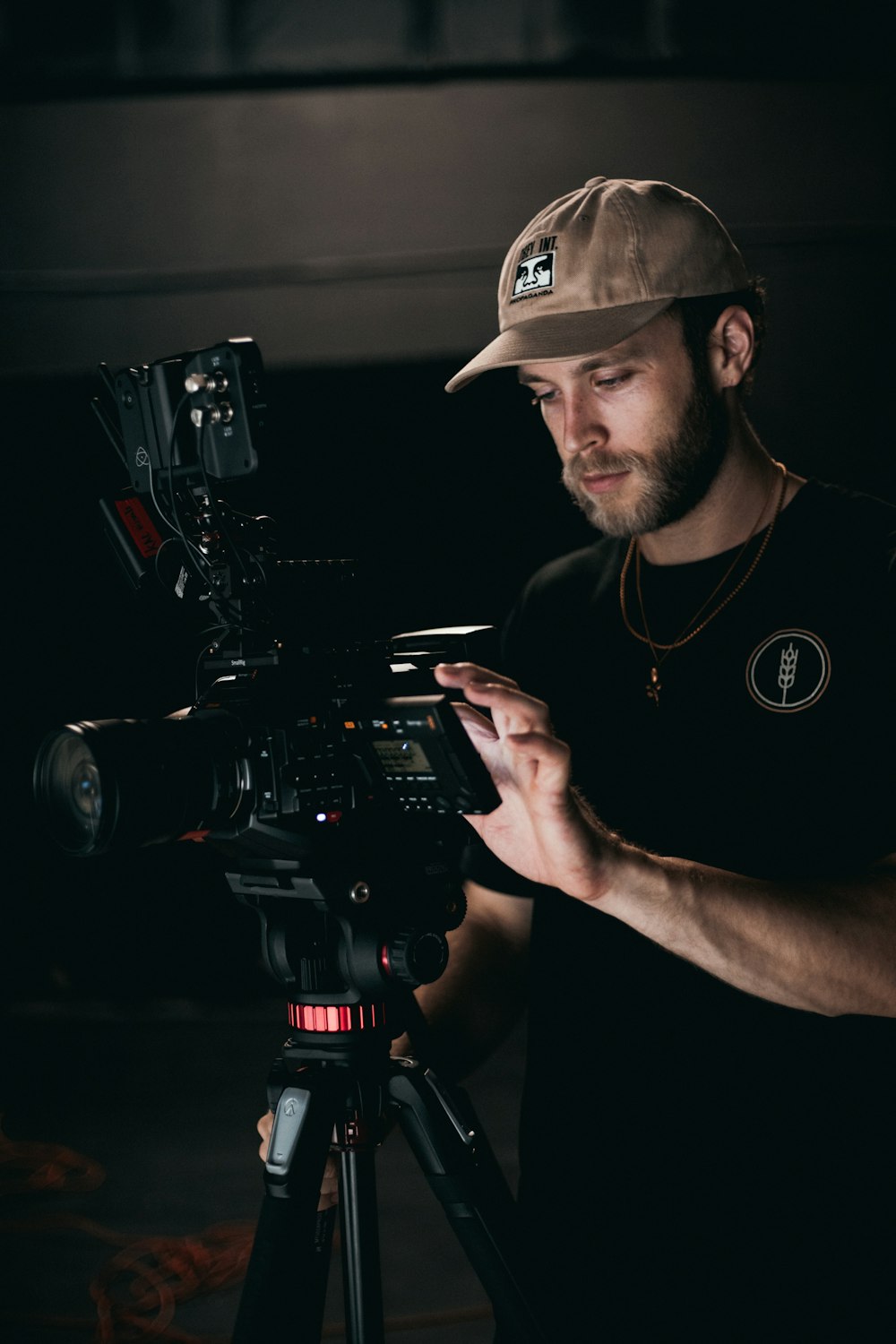 man in black crew neck t-shirt holding black video camera