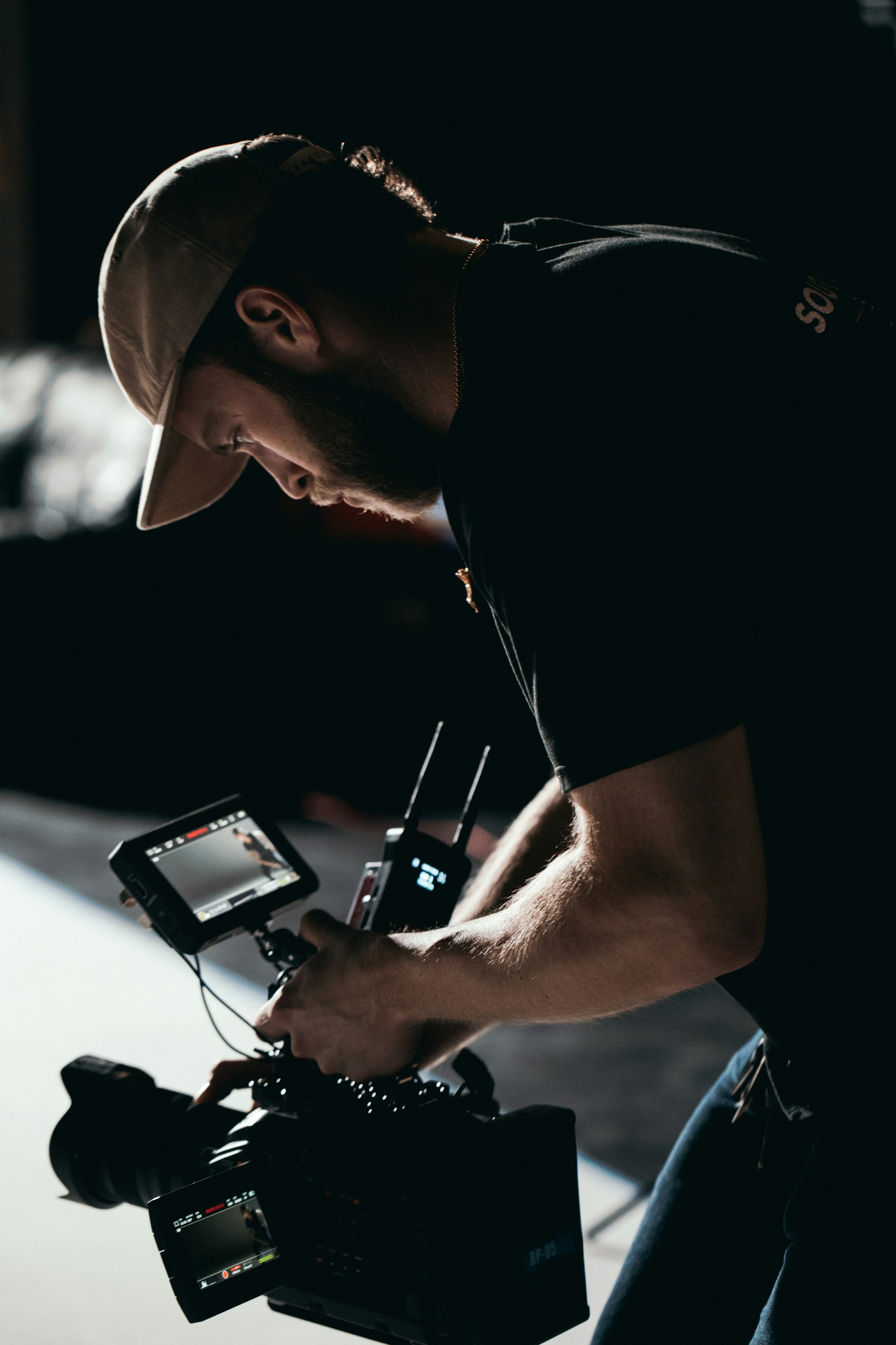 man in black t-shirt holding black dslr camera