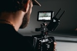 man in black shirt holding video camera
