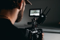 man in black shirt holding video camera