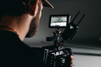 man in black shirt holding video camera