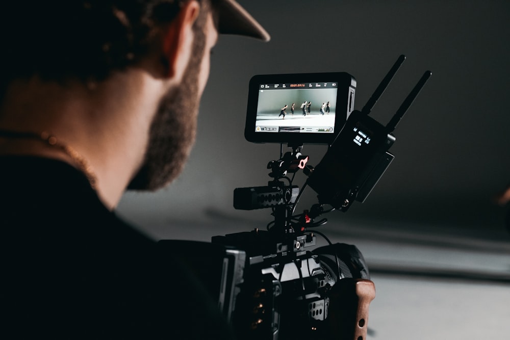 man in black shirt holding video camera