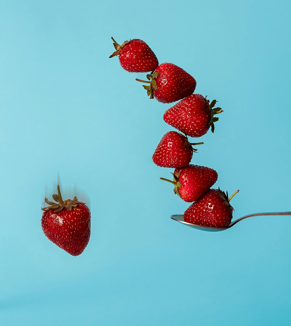 red strawberries on pink surface