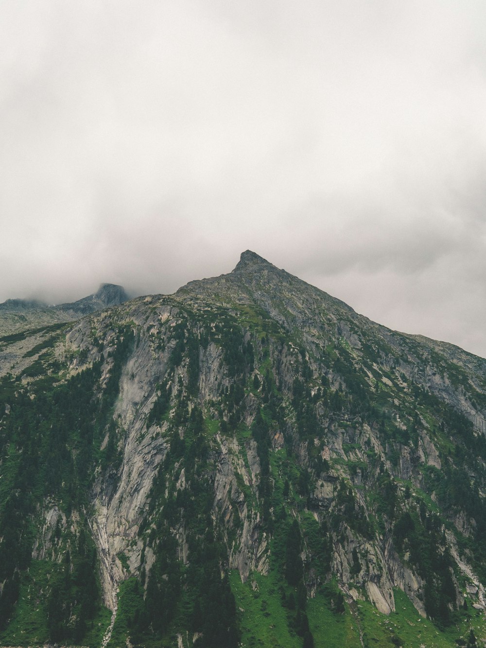 green and black mountain under white clouds during daytime