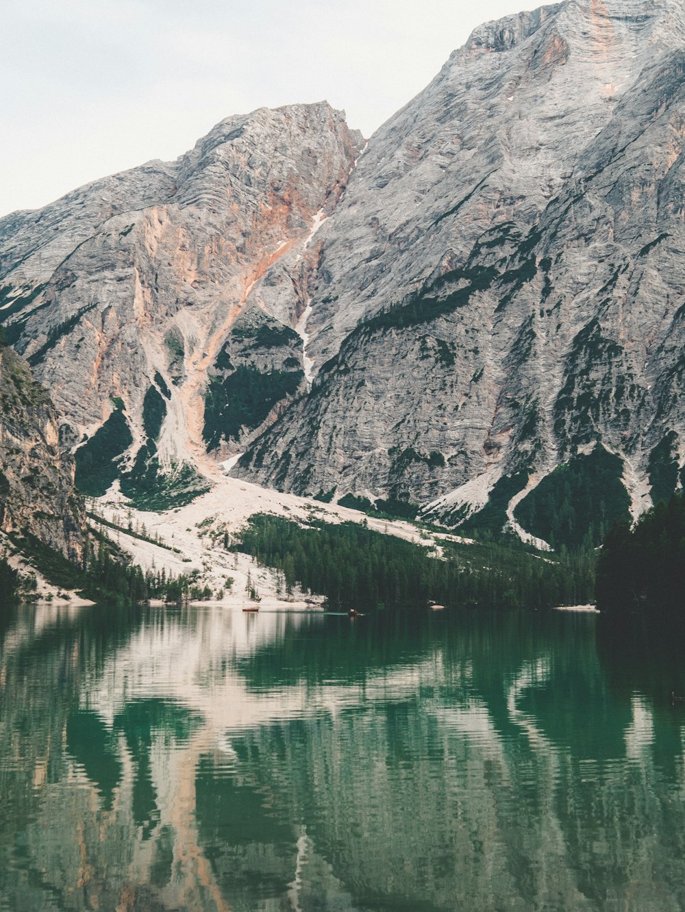 gray and white mountain near body of water during daytime