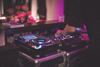 person playing dj controller on stage