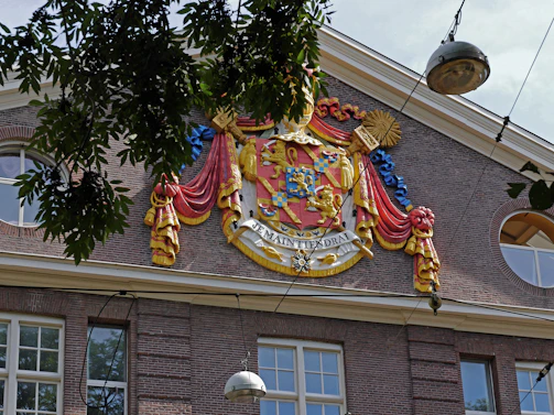 A newly designed district coat of arms displayed alongside historical documents.