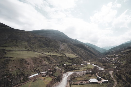 green mountains under white cloudy sky during daytime in Gilan Province Iran