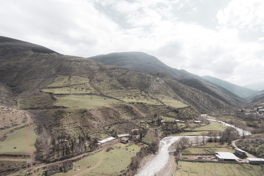 green and brown mountains under white clouds during daytime