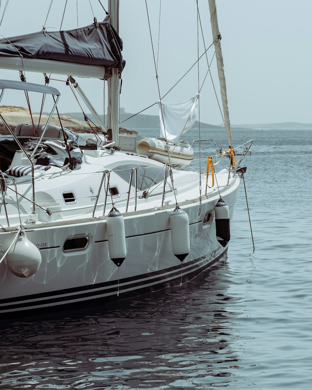 white and black boat on body of water during daytime