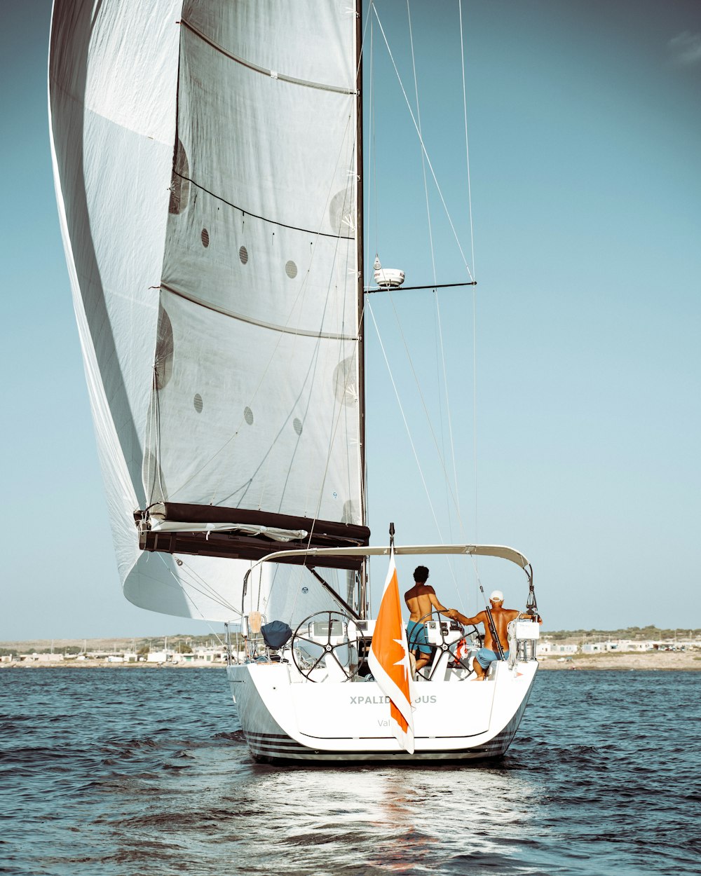 white sail boat on sea during daytime