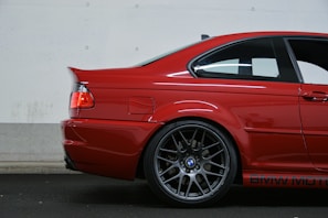 Rearview camera installation on a BMW, highlighting the camera and wiring.