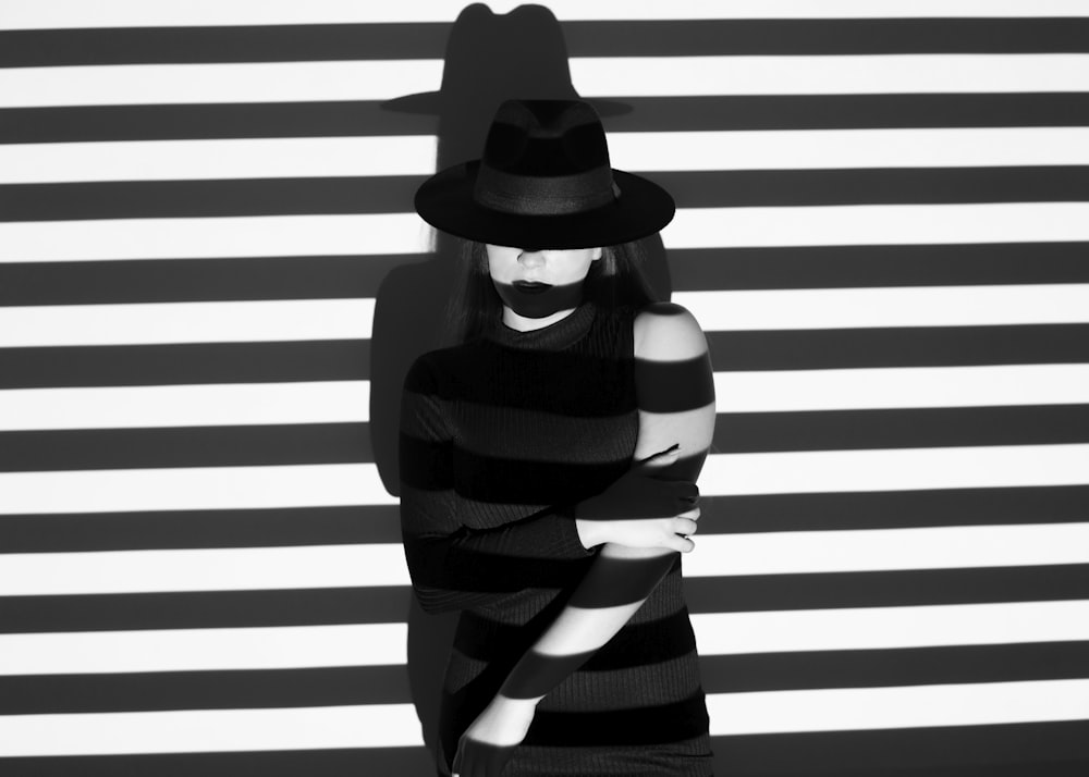 woman in black and white stripe long sleeve shirt wearing black hat