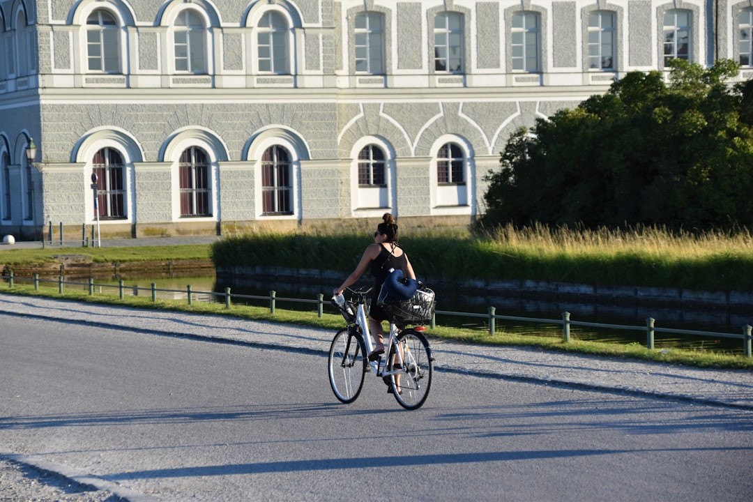 man in black shirt riding bicycle on road during daytime