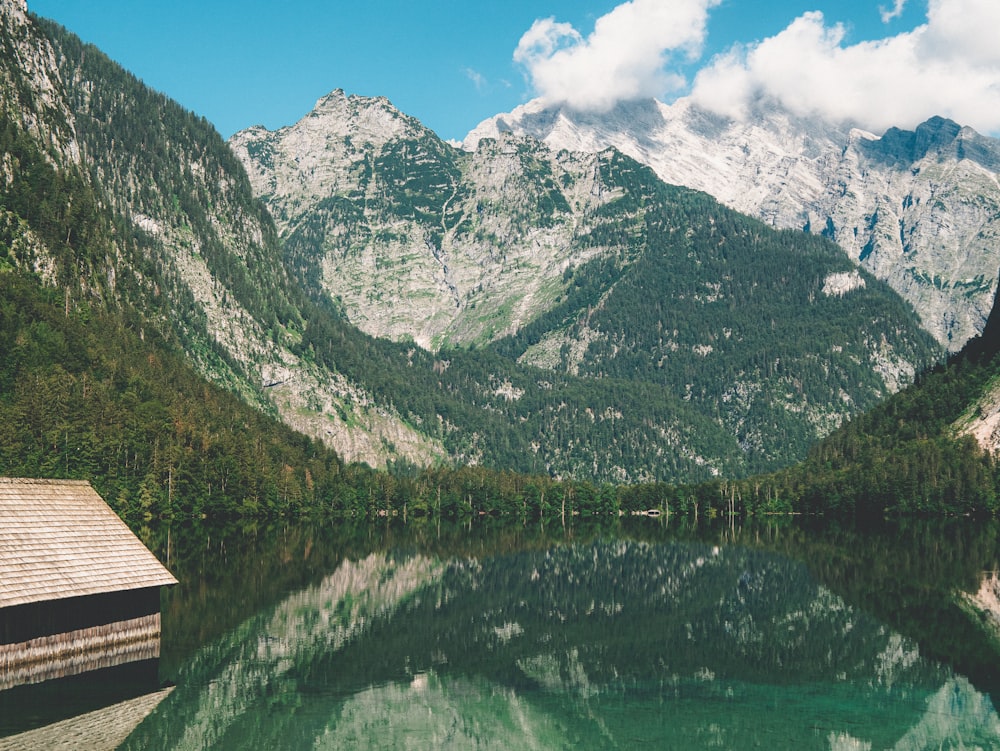 green and gray mountains beside lake during daytime