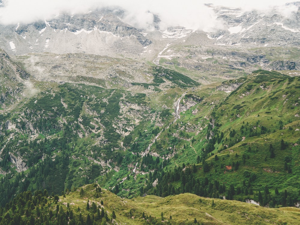 green and white mountains under white clouds during daytime