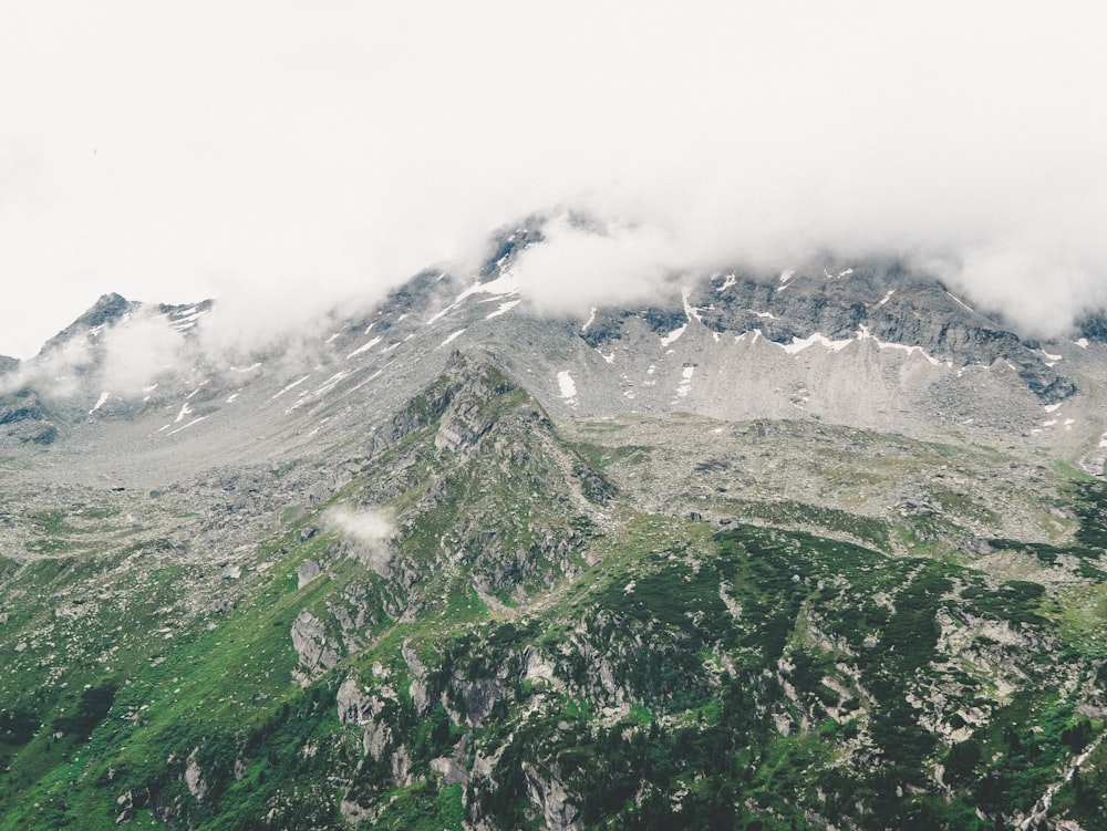 green and white mountain under white clouds during daytime