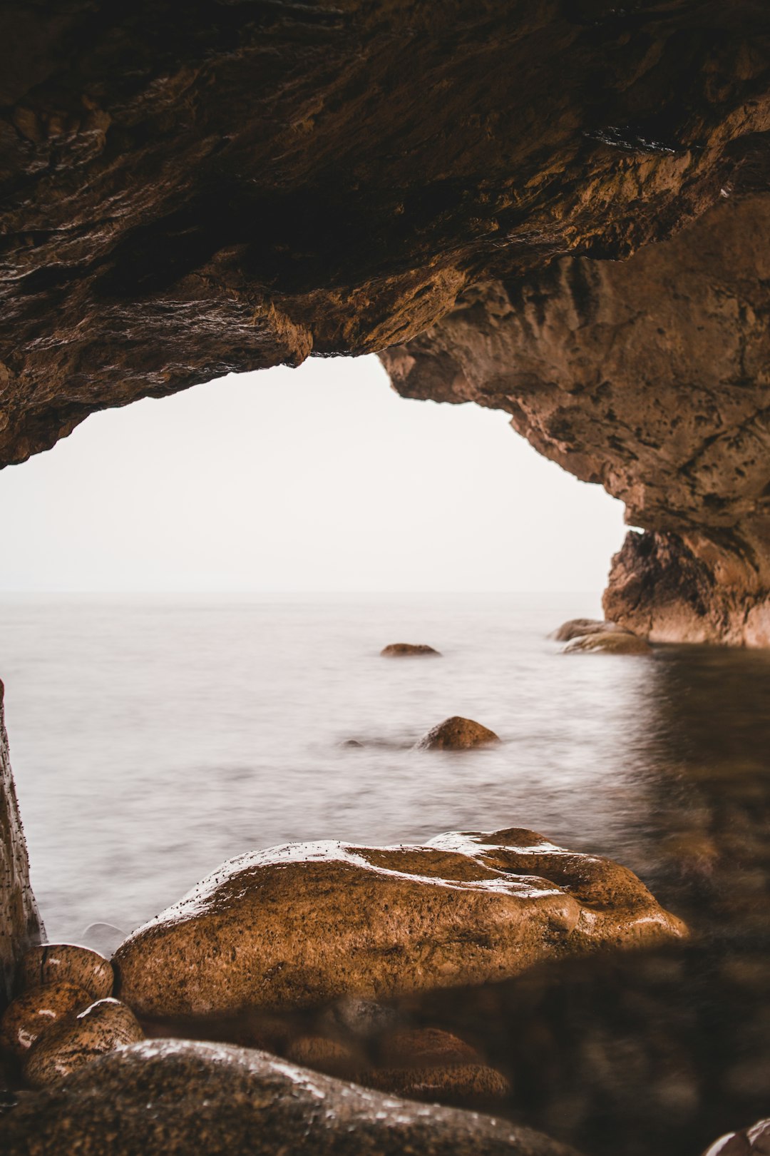 brown rock formation on sea during daytime