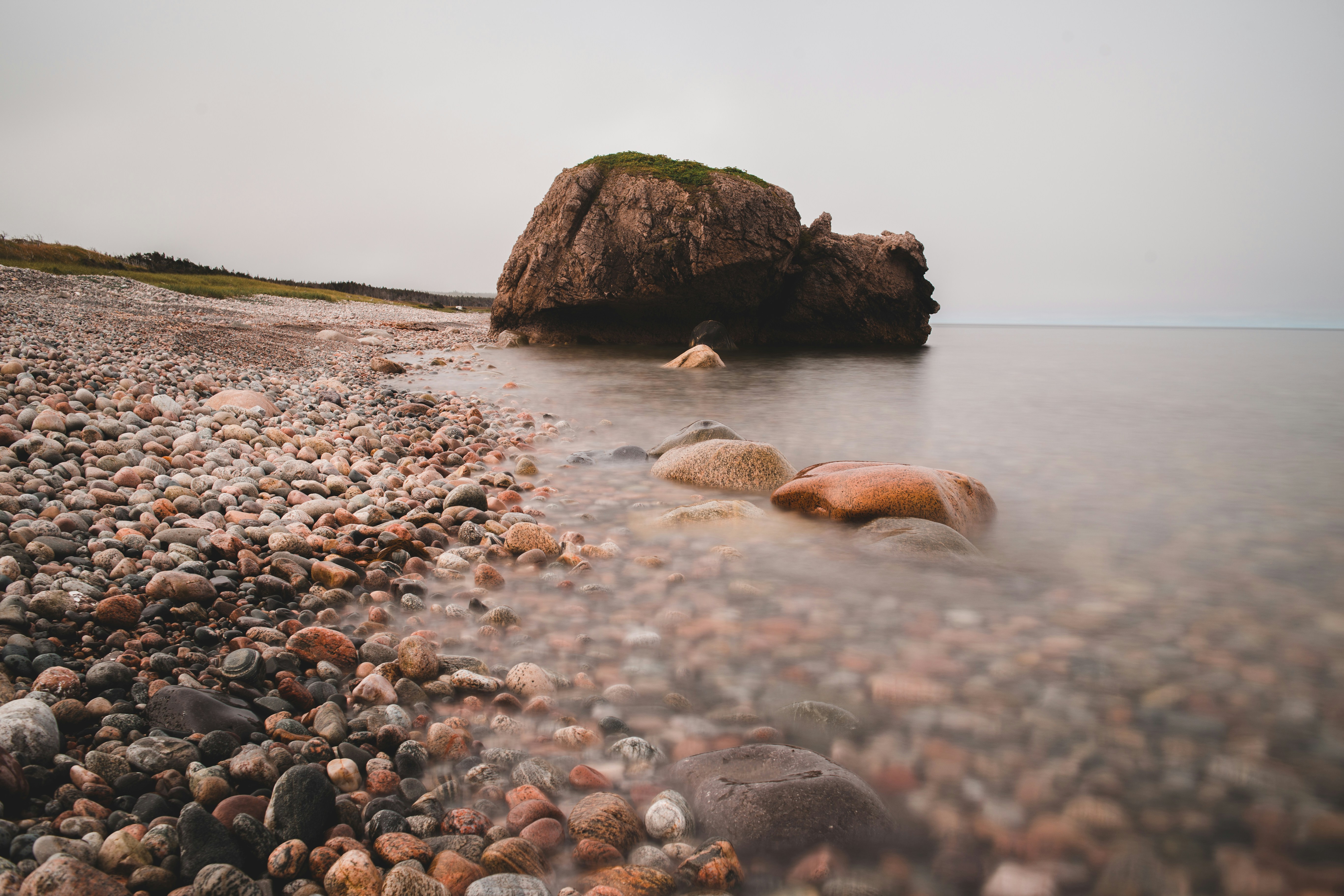 brown rock formation on sea shore during daytime