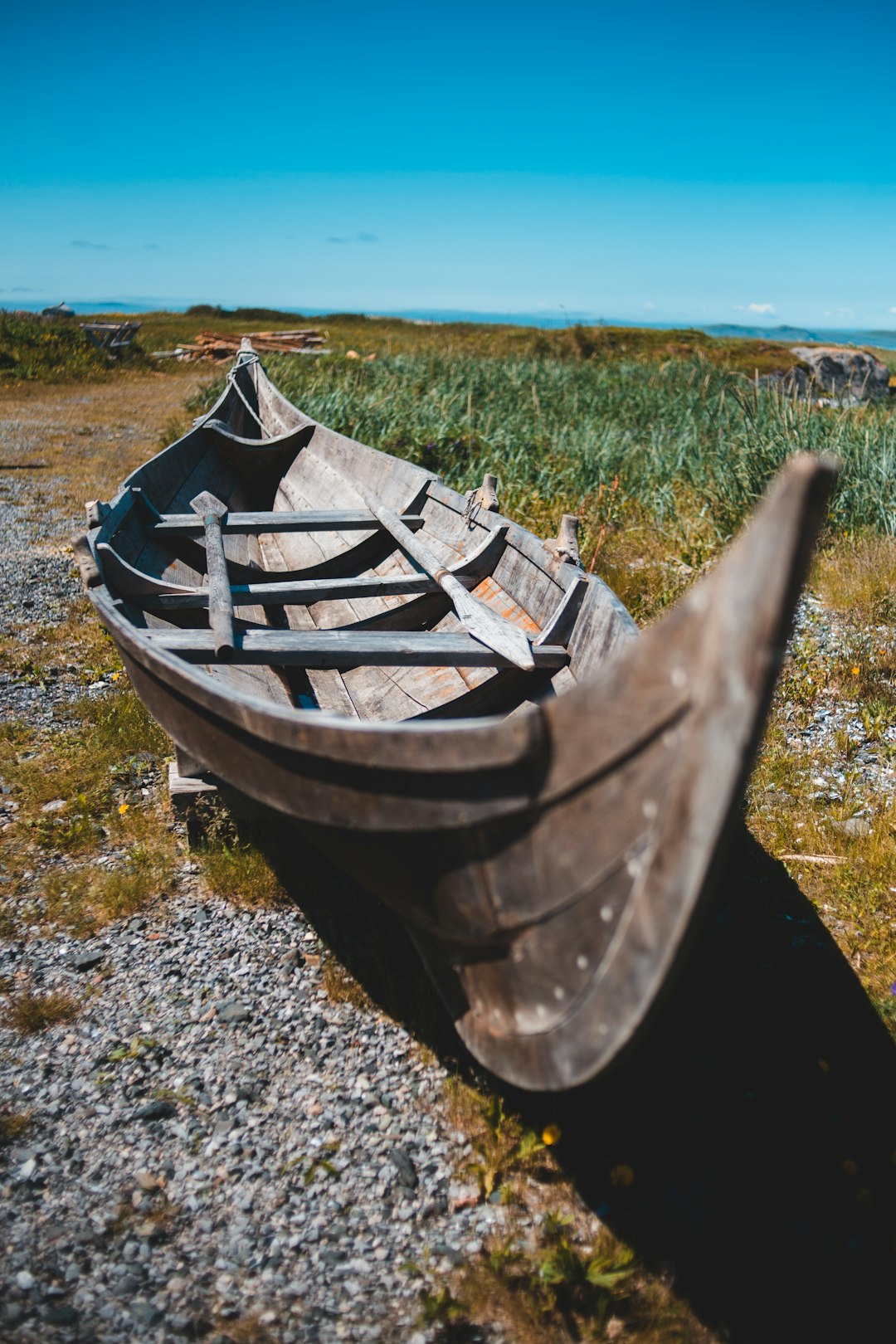 brown wooden boat on gray sand during daytime