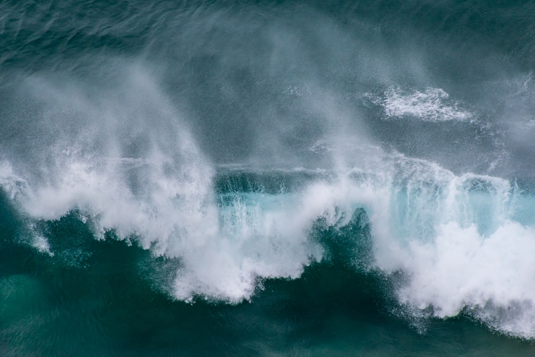 ocean waves crashing on shore during daytime