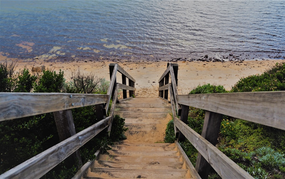 brown wooden staircase on beach during daytime