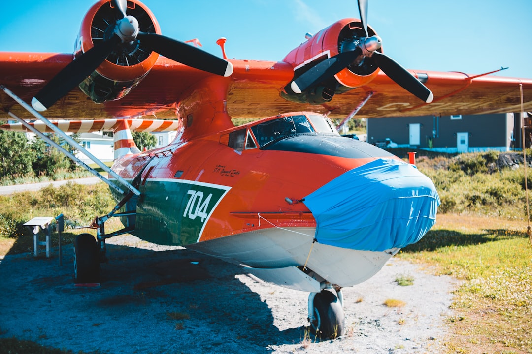 red and blue plane on white sand during daytime