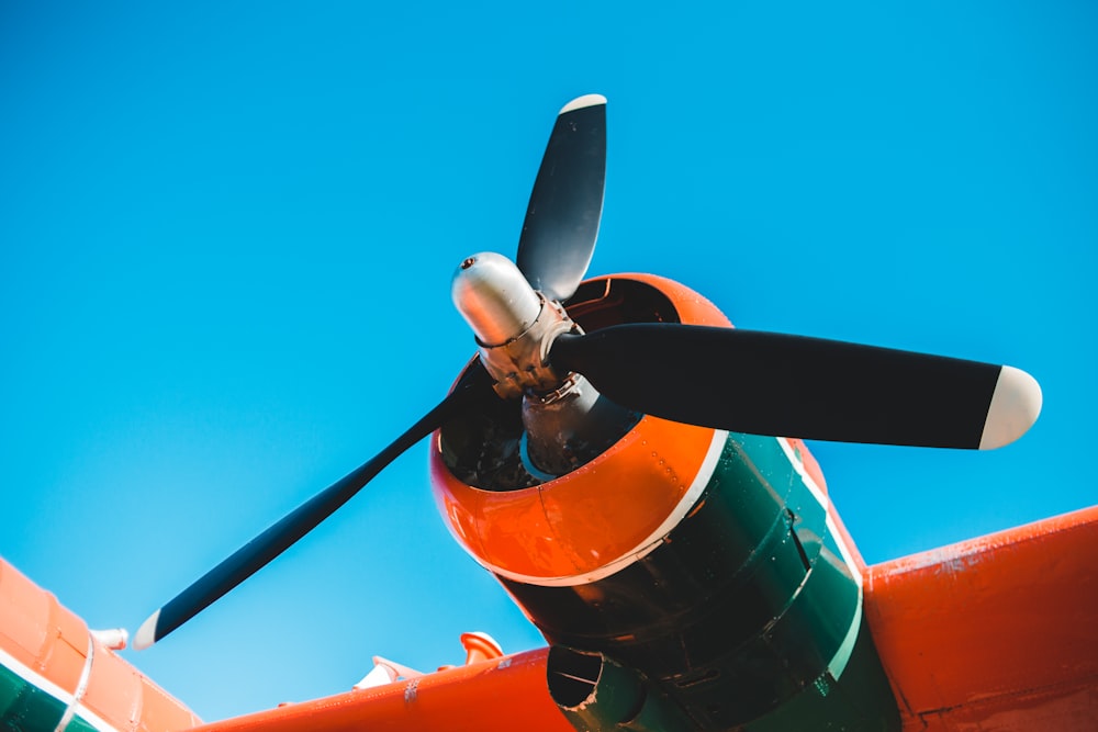 orange and black plane under blue sky during daytime