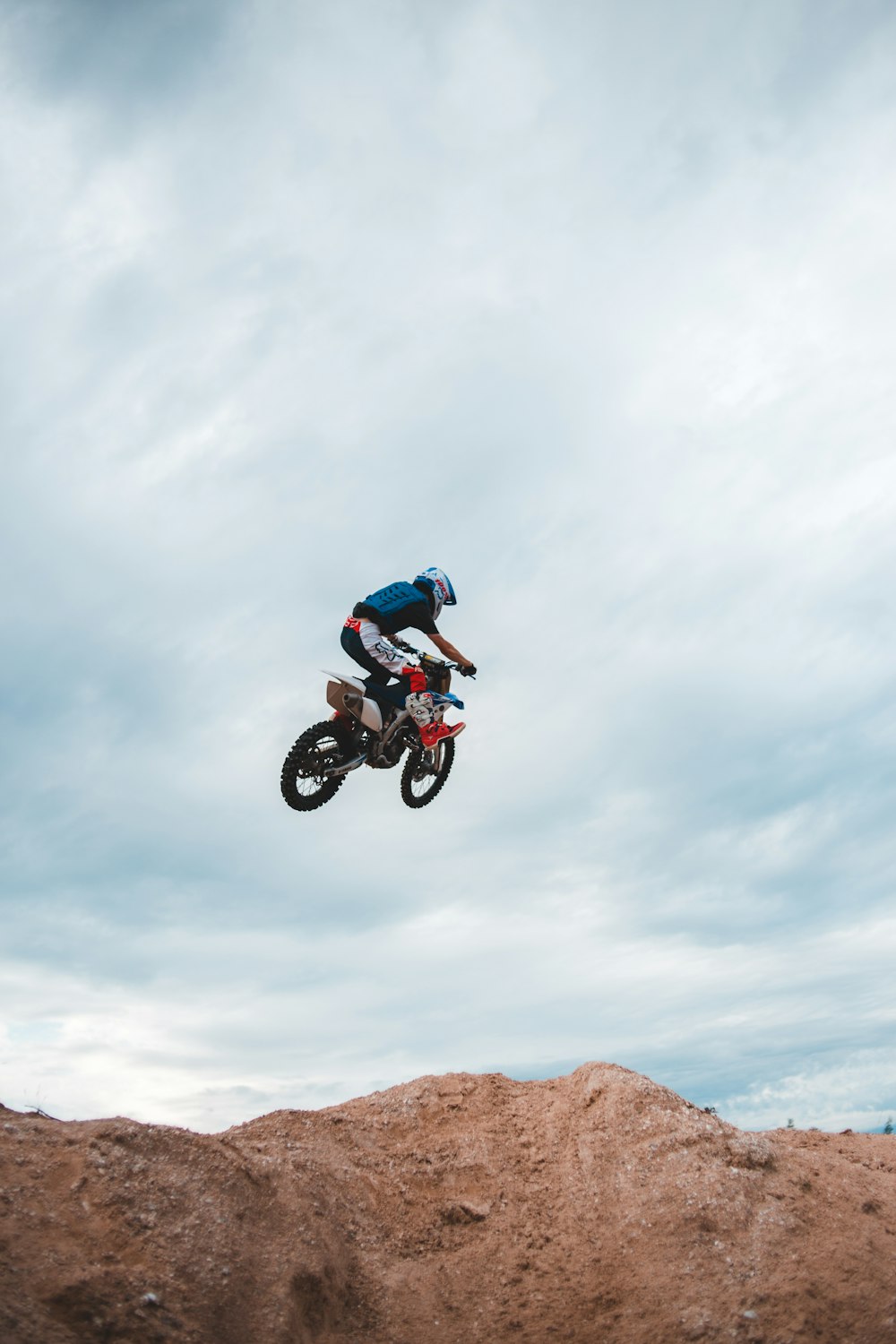 Foto Homem em branco e terno de corrida azul que monta motocross azul moto  de terra – Imagem de Roda grátis no Unsplash