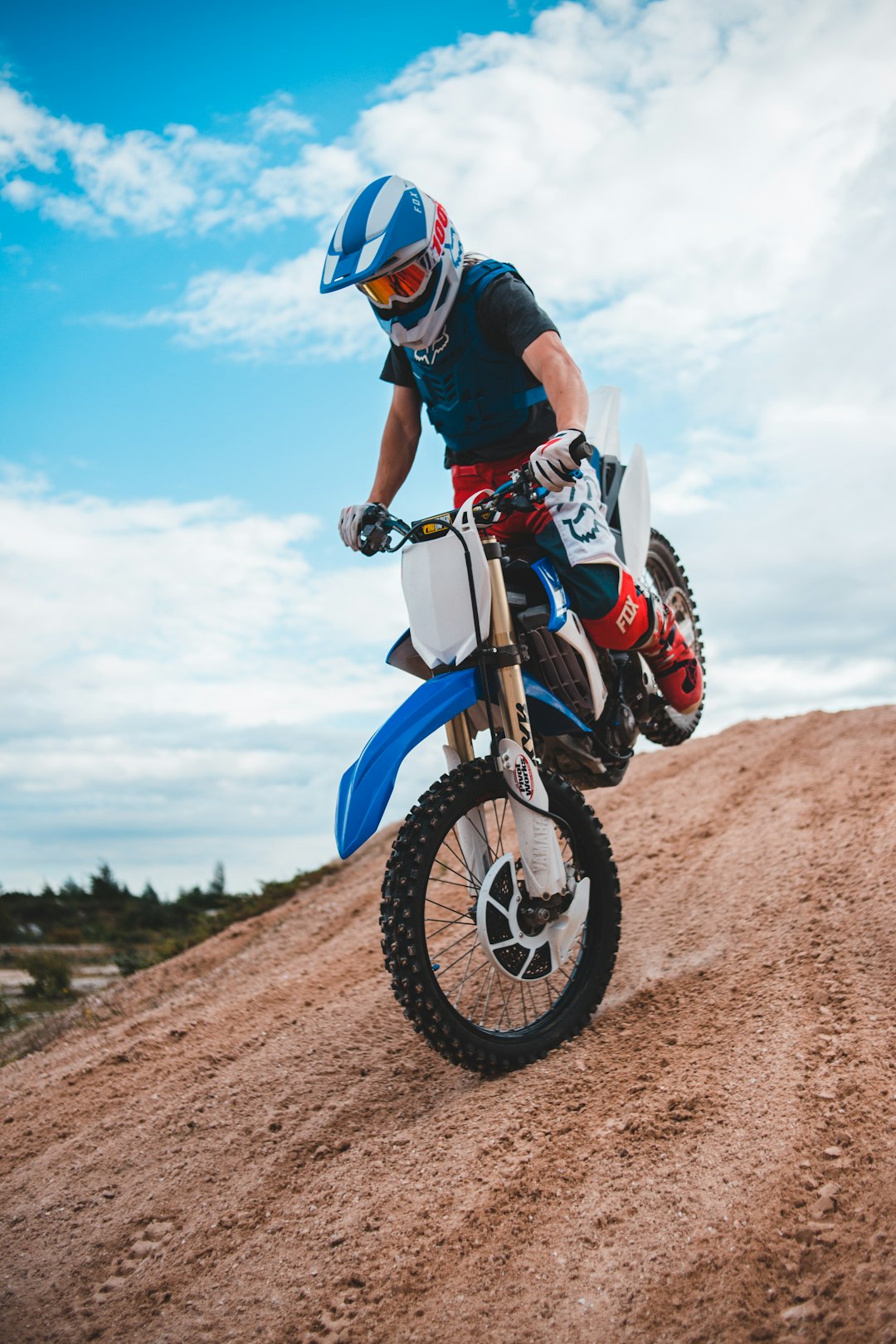 man in black and red motorcycle suit riding motocross dirt bike