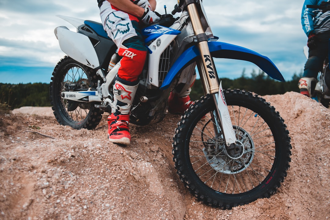 man in red and white motocross suit riding motocross dirt bike