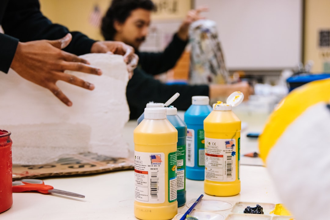 yellow and white plastic bottle on white table