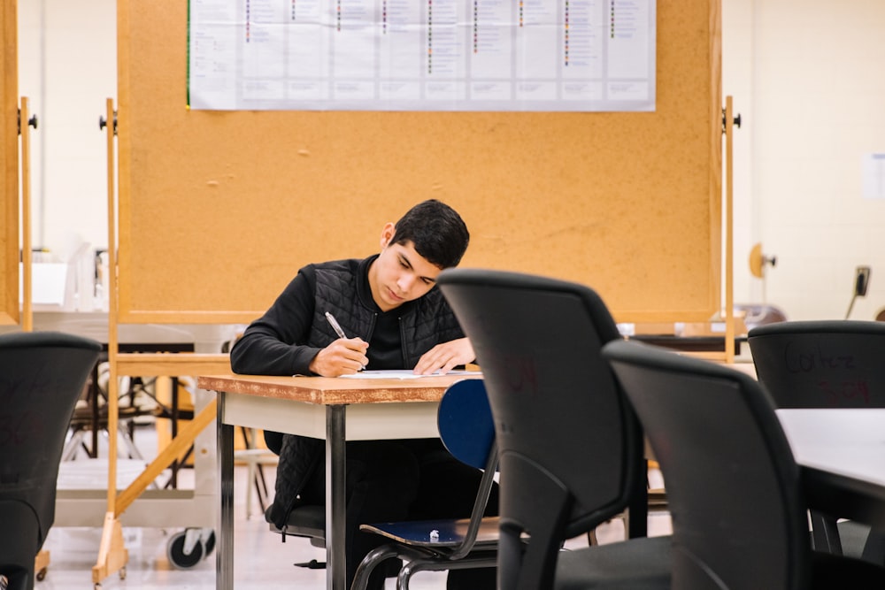 man in black long sleeve shirt sitting on black chair