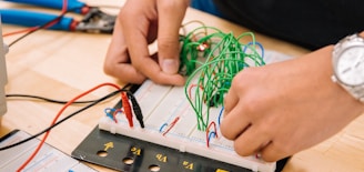 person holding black and white audio mixer