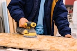 person holding black and yellow cordless hand drill