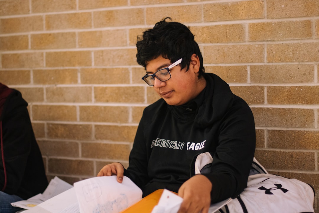 man in black hoodie wearing black framed eyeglasses