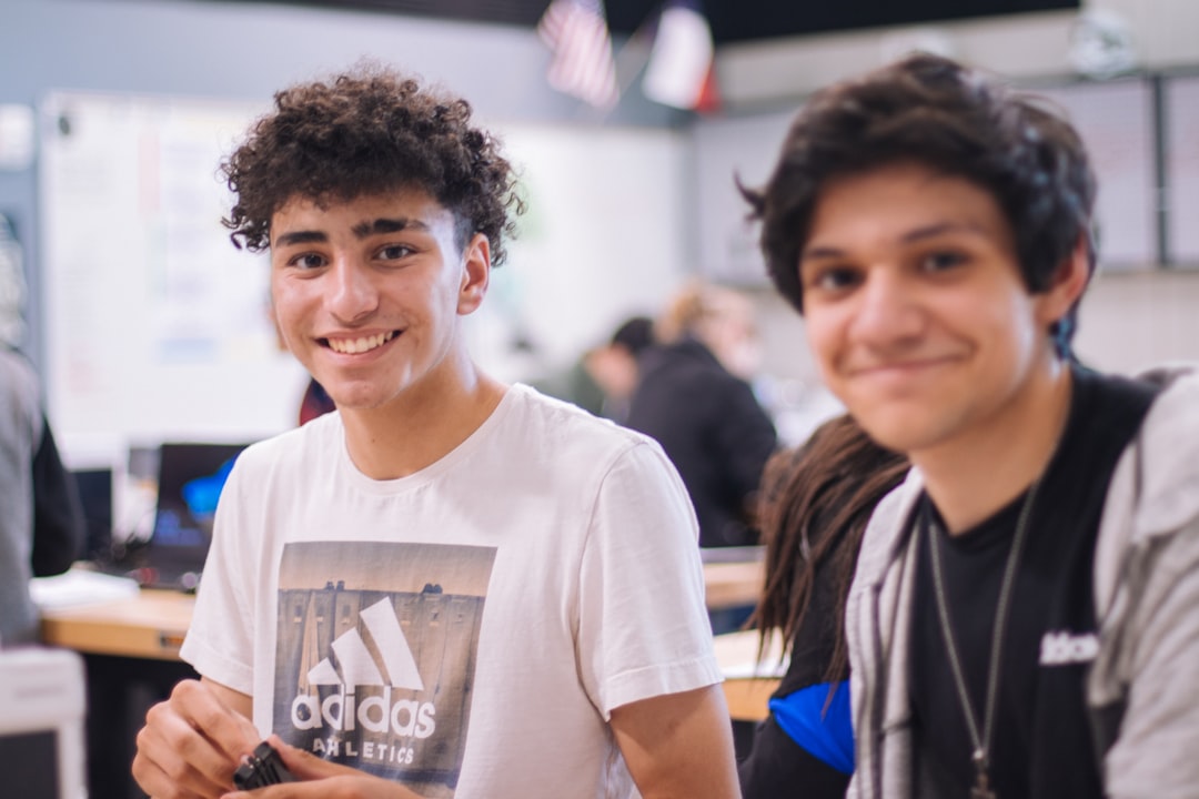 man in white crew neck t-shirt smiling