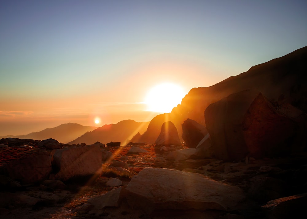 brown rocky mountain during sunset