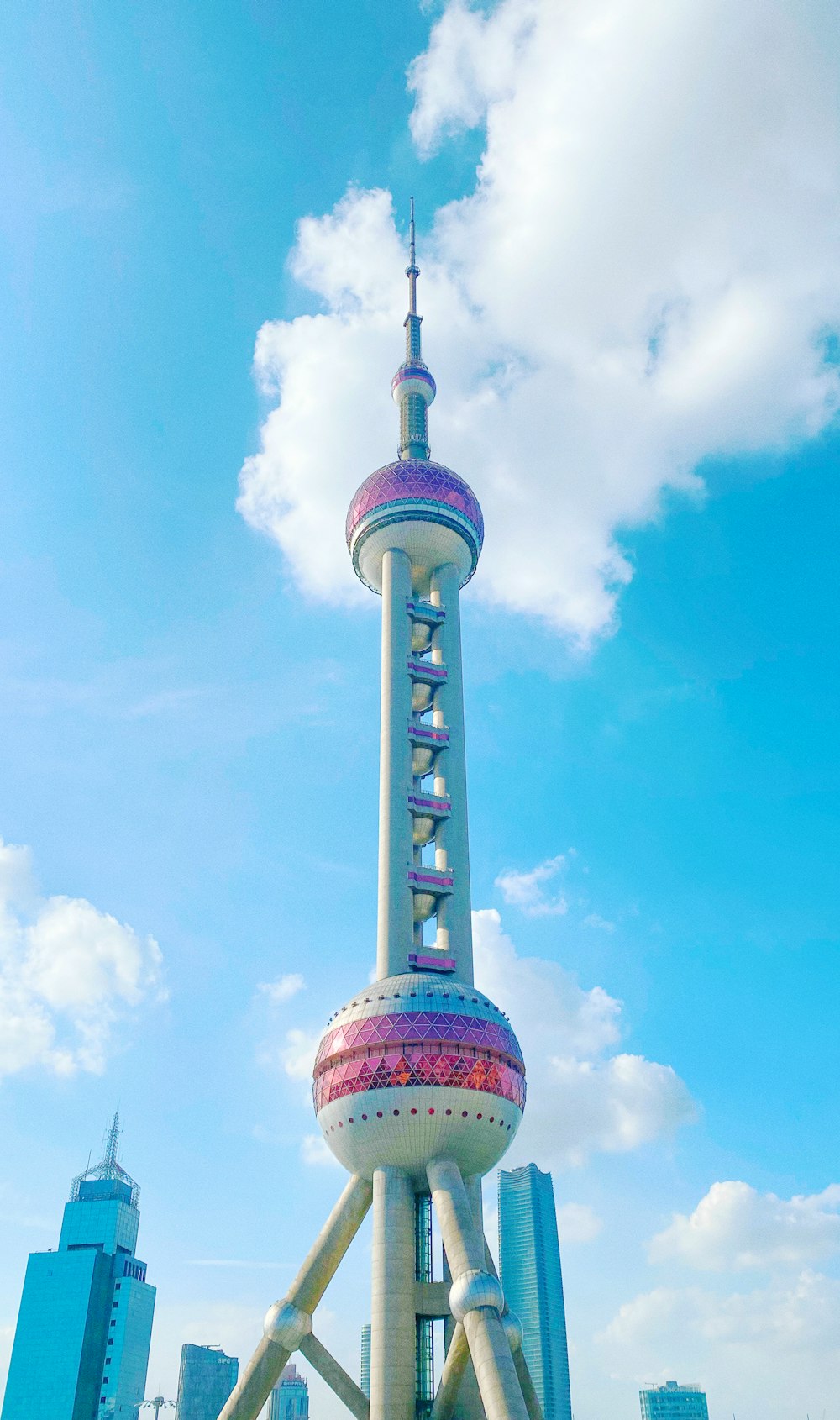white and pink concrete tower under blue sky during daytime